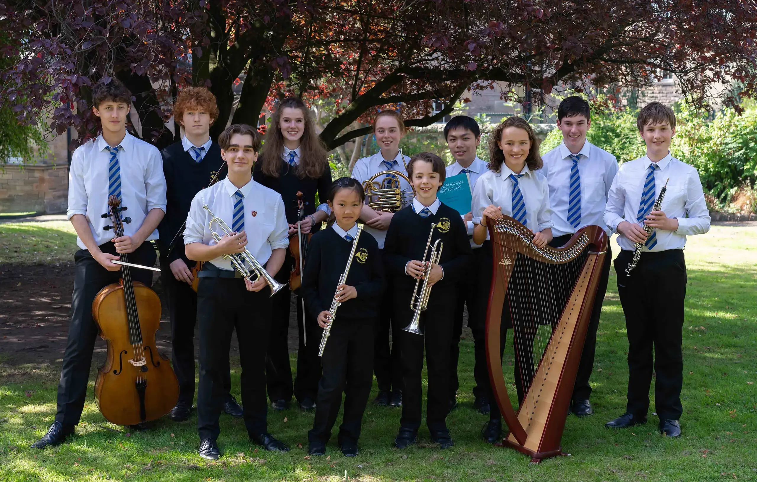 St Mary's Music School pupils in garden with their instruments